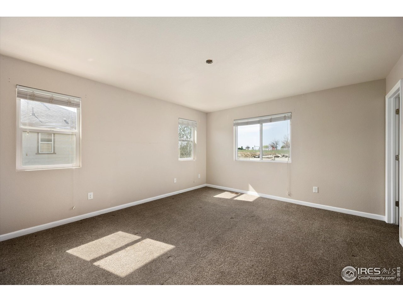 4874 Sandy Ridge Avenue Firestone, CO 80504 - Photo 14 of 35 a view of an empty room with a window