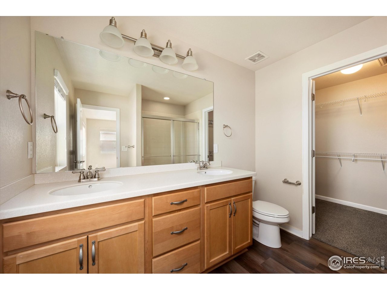 4874 Sandy Ridge Avenue Firestone, CO 80504 - Photo 15 of 35 a bathroom with a granite countertop toilet a sink and a mirror