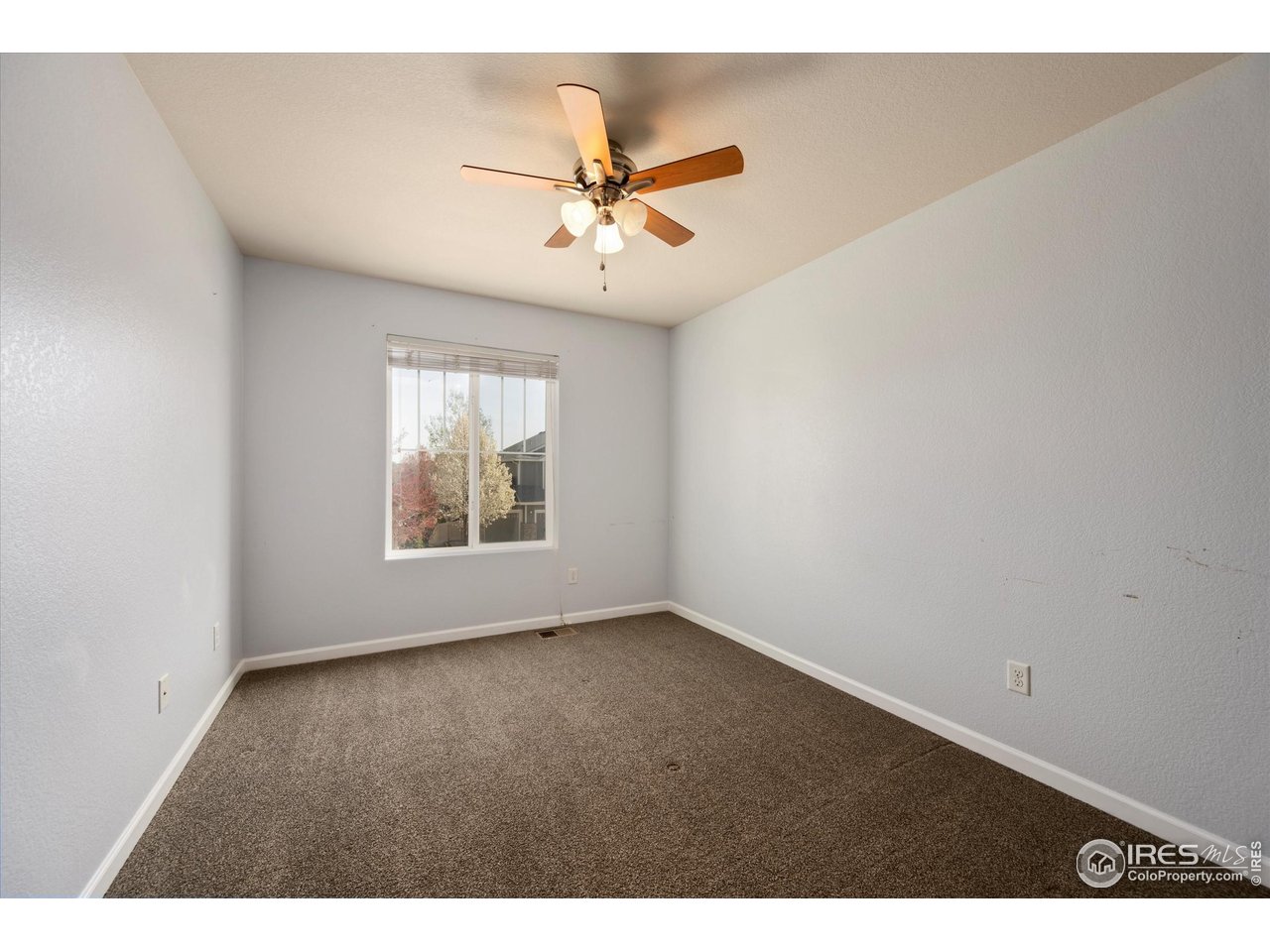 4874 Sandy Ridge Avenue Firestone, CO 80504 - Photo 18 of 35 a view of an empty room with a window