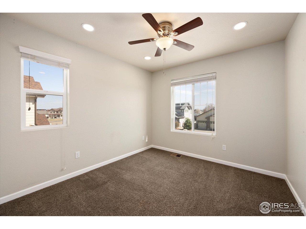 4874 Sandy Ridge Avenue Firestone, CO 80504 - Photo 19 of 35 an empty room with windows and fan