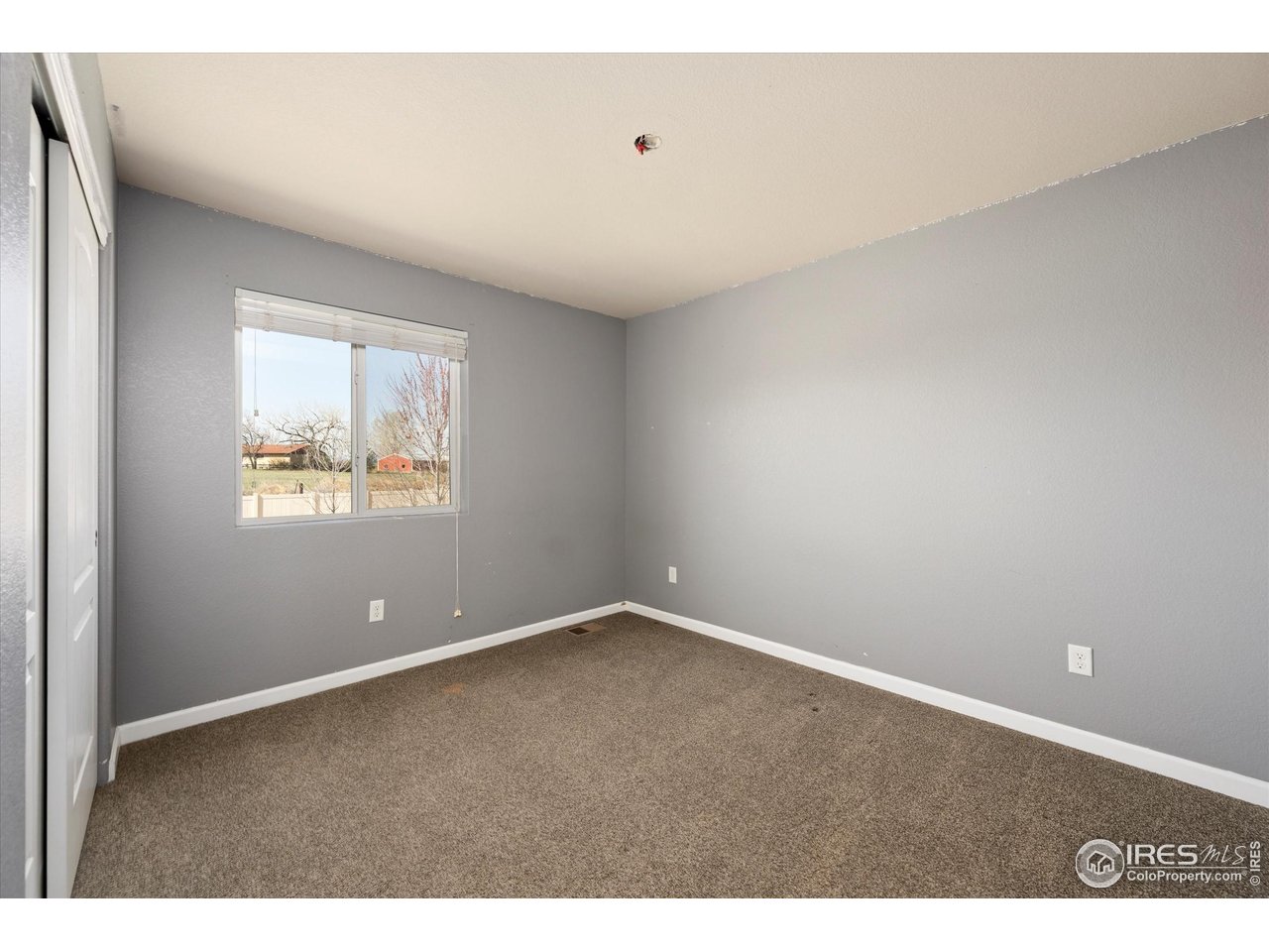 4874 Sandy Ridge Avenue Firestone, CO 80504 - Photo 21 of 35 a view of an empty room with a window