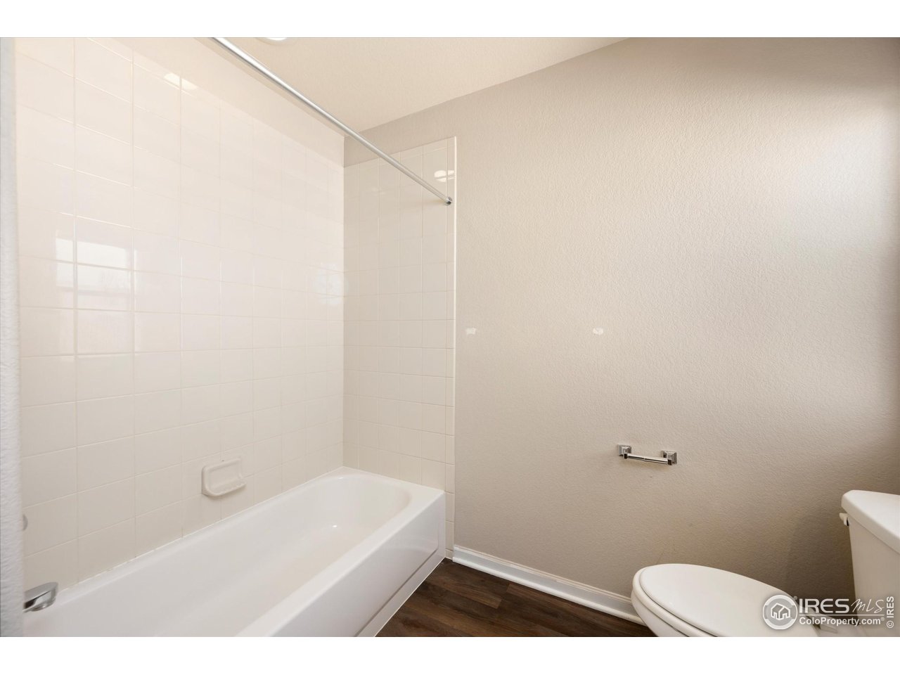 4874 Sandy Ridge Avenue Firestone, CO 80504 - Photo 23 of 35 a bathroom with a bathtub and a toilet