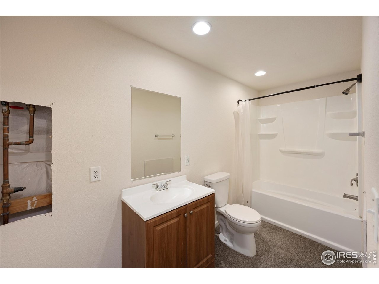 4874 Sandy Ridge Avenue Firestone, CO 80504 - Photo 29 of 35 a bathroom with a sink a toilet and shower
