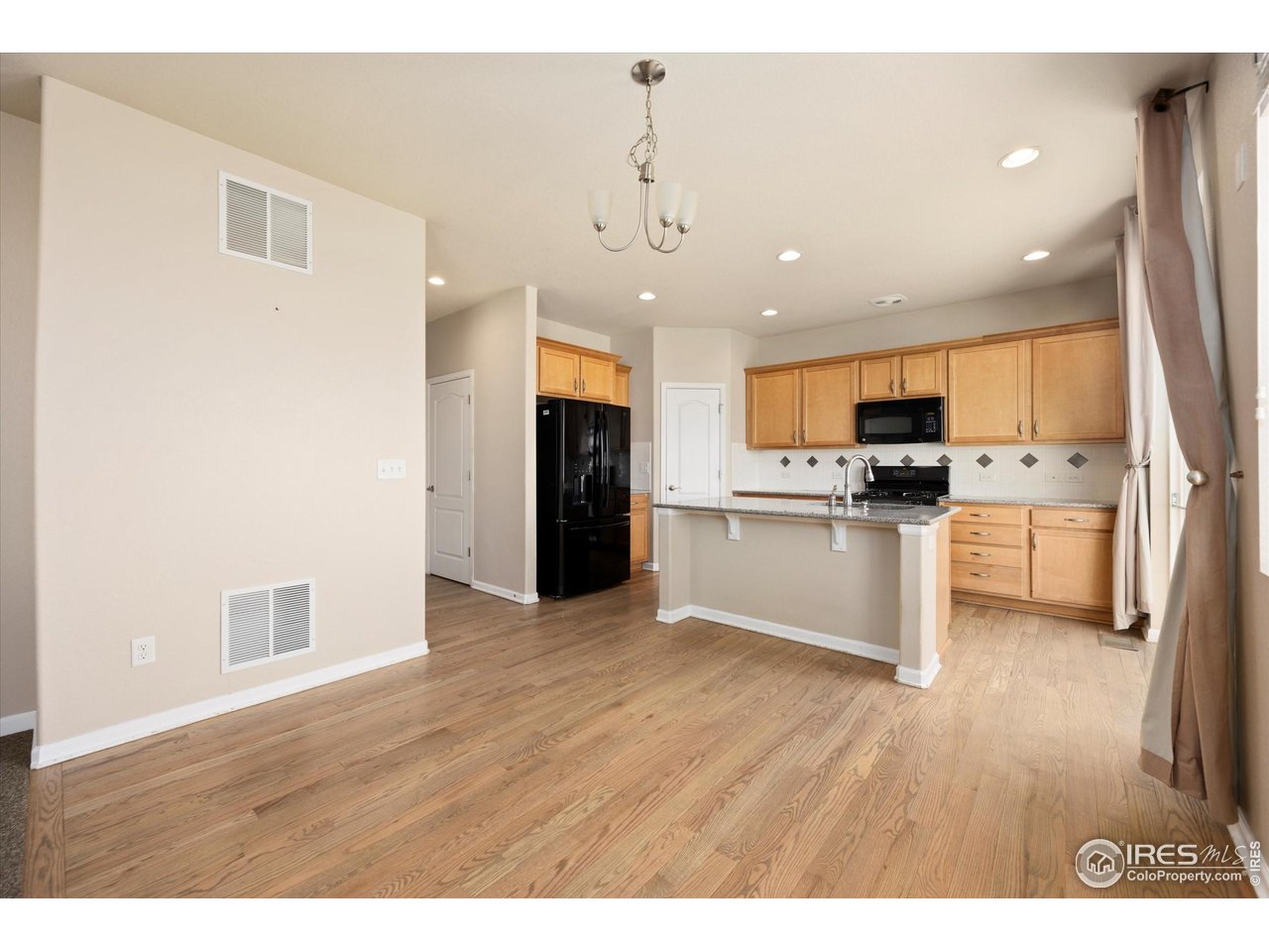 4874 Sandy Ridge Avenue Firestone, CO 80504 - Photo 8 of 35 a view of kitchen with refrigerator stove microwave and cabinets