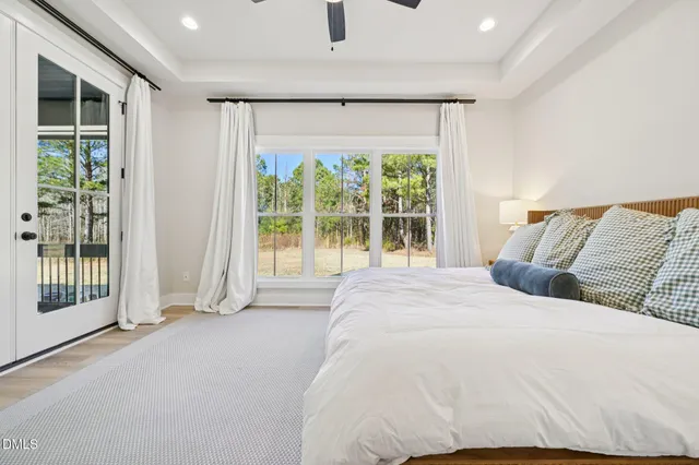 a spacious bedroom with a large bed and a large window