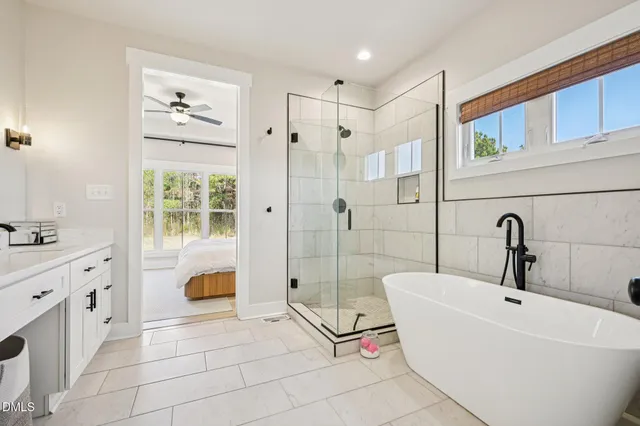 a spacious bathroom with a tub sink and shower