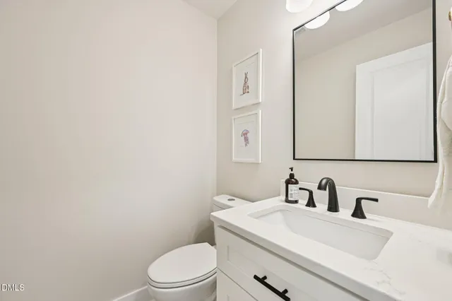 a bathroom with a sink a toilet and mirror