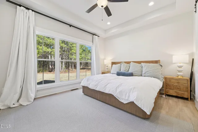 a spacious bedroom with a bed and large window