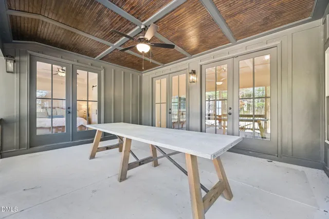 a view of a room with table and chairs