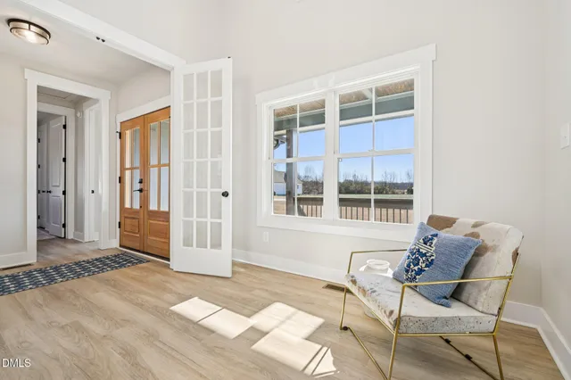 a view of a bedroom with furniture and windows