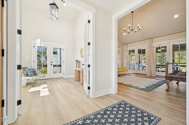 a view of a livingroom with furniture wooden floor and a chandelier