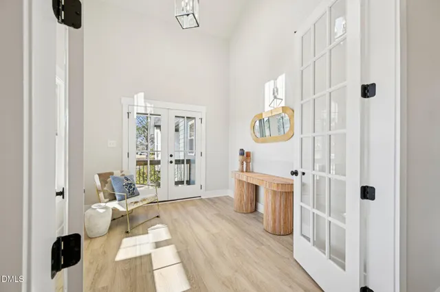 a spacious bedroom with a bed and a chandelier