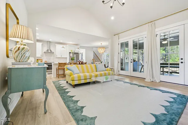 a bedroom with furniture and a large window