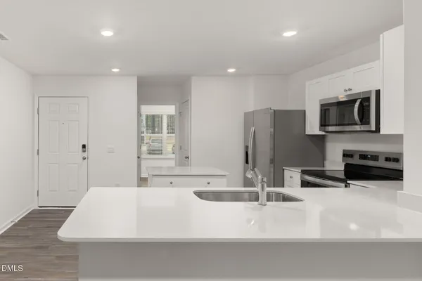 a kitchen with a refrigerator stove and microwave