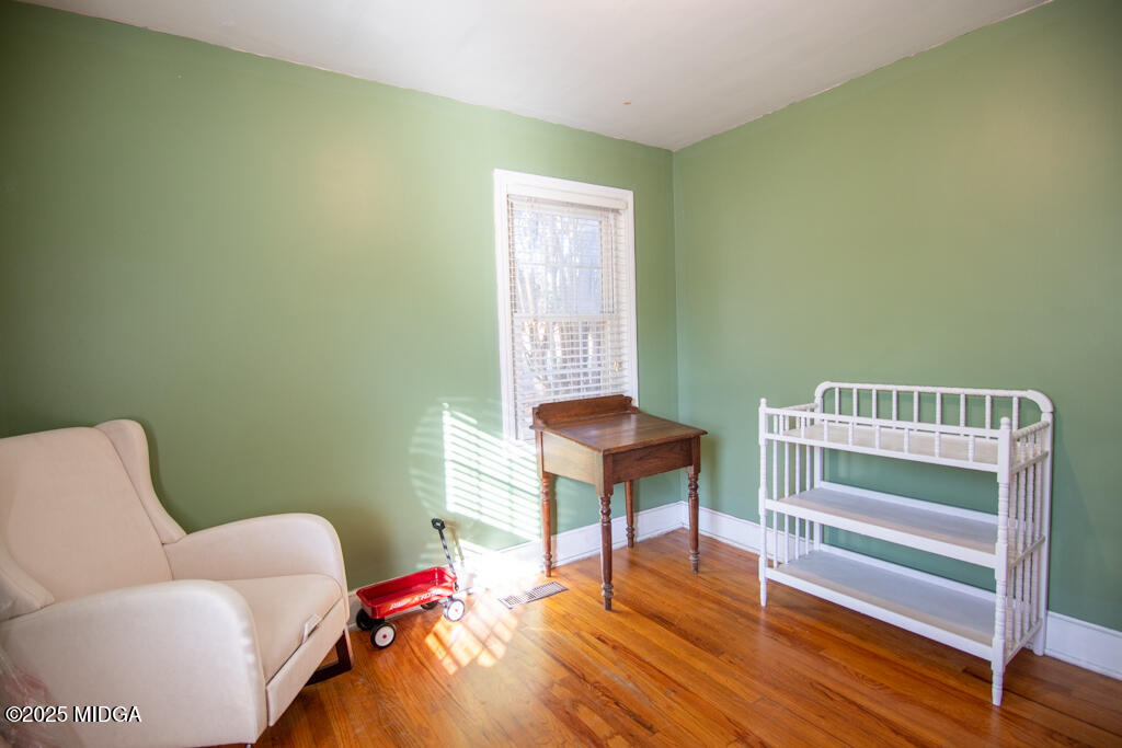 3160 Walden Road Macon, GA 31216 - Photo 15 of 32 a bedroom with a bed and a chair
