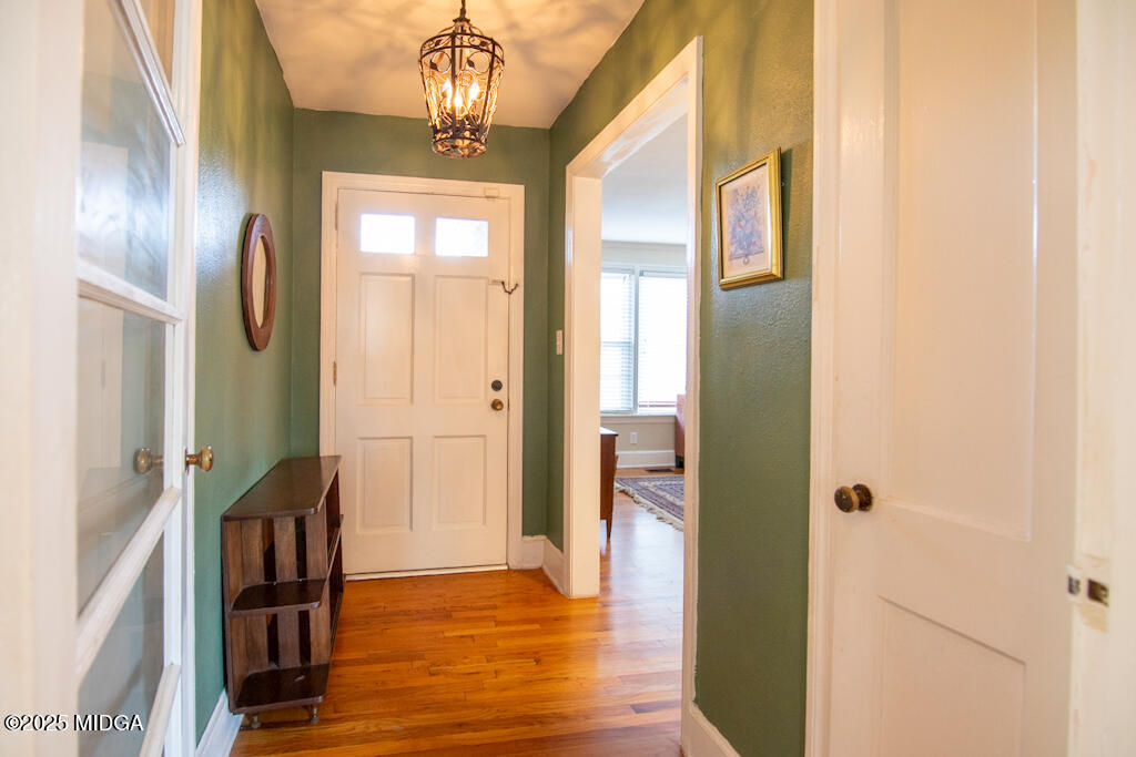 3160 Walden Road Macon, GA 31216 - Photo 8 of 32 a view of a hallway with wooden floor and a dining room
