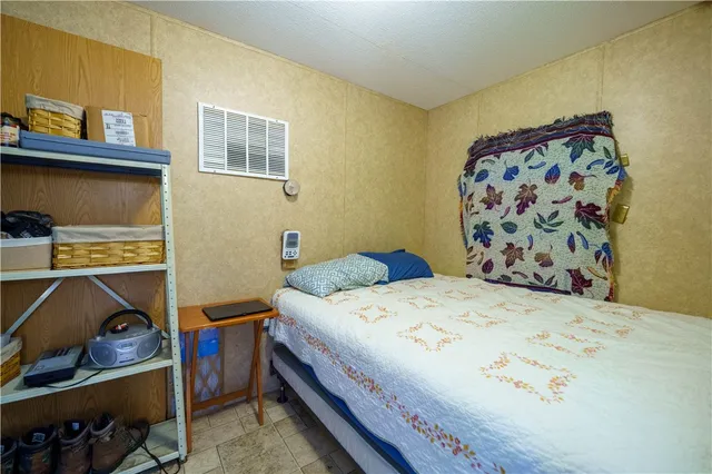 a bathroom with a toilet sink vanity and mirror