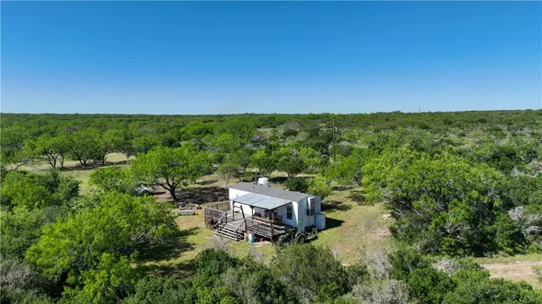 a view of a house with backyard porch and sitting area