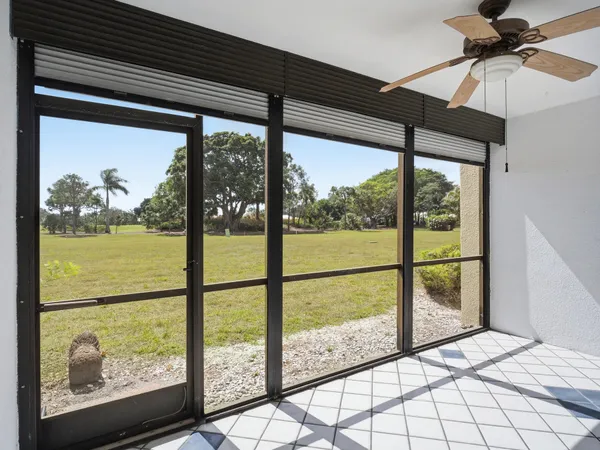 a view of a house with a large window and wooden fence