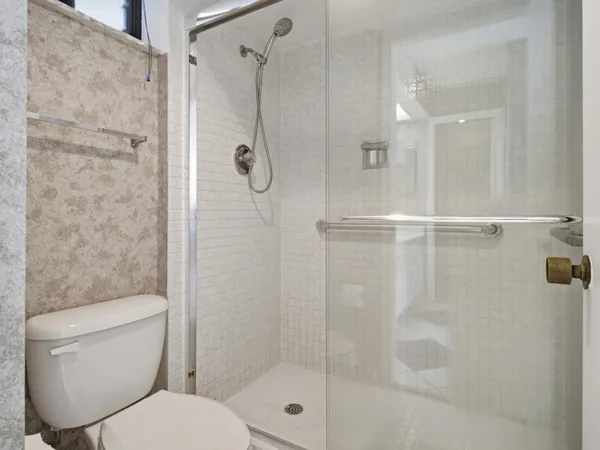 a bathroom with a shower sink and mirror