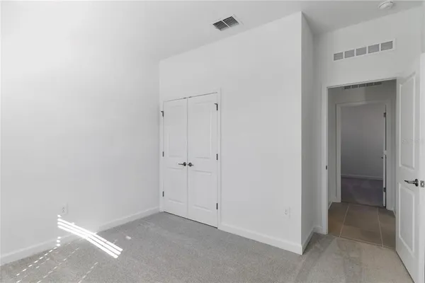 a bathroom with a granite countertop bathtub shower sink vanity mirror and toilet