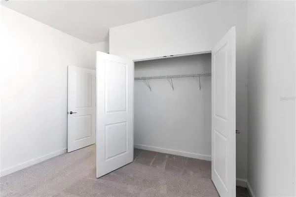 a large white kitchen with a large window