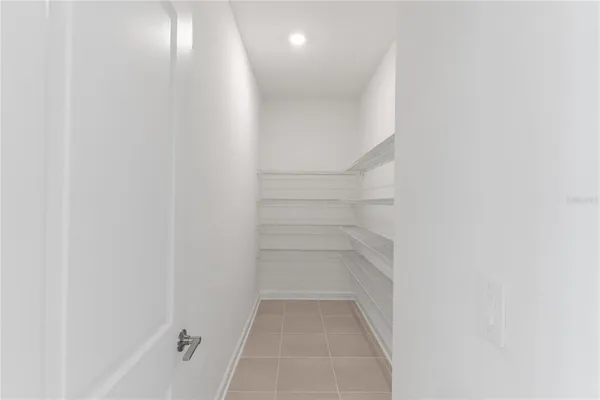 a large kitchen with stainless steel appliances a large counter top a stove and a refrigerator