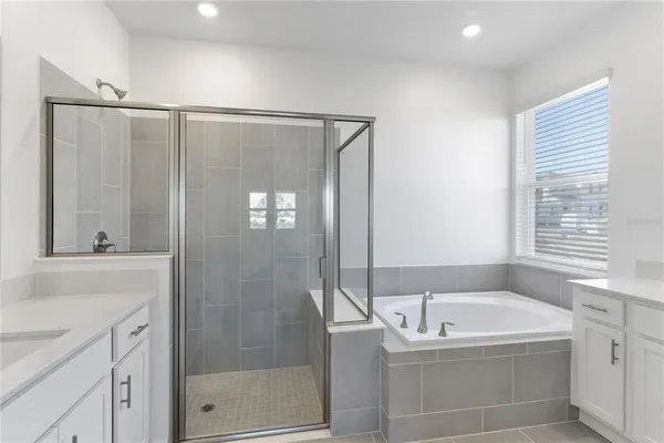 a bathroom with a bathtub and a shower