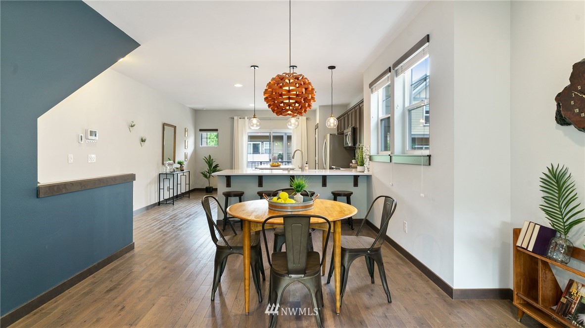 7170 Shinkle Place Southwest Seattle, WA 98106 - Photo 11 of 29 a view of a dining room with furniture and wooden floor