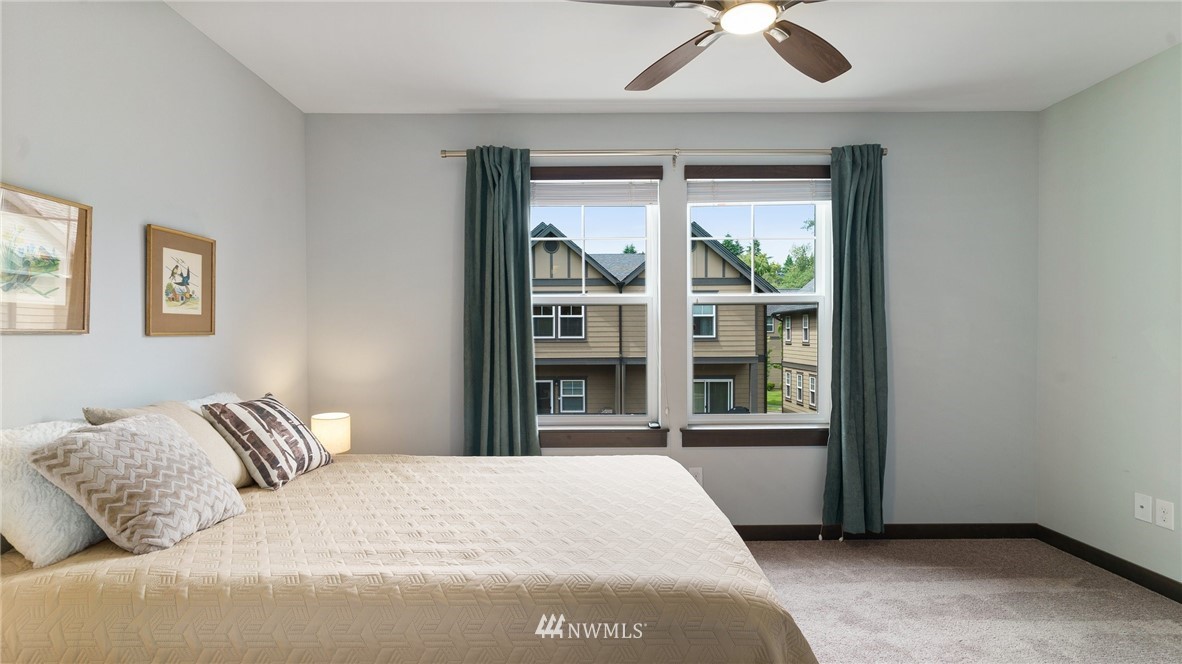 7170 Shinkle Place Southwest Seattle, WA 98106 - Photo 22 of 29 a bedroom with a large bed and a large window