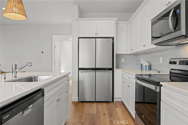 a view of a dining room with furniture and a potted plant