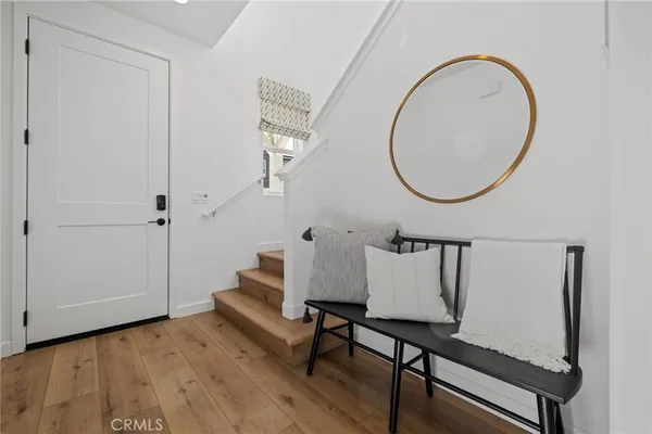 a view of entryway and hall with wooden floor