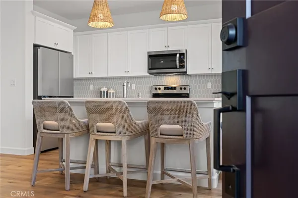 a kitchen with stainless steel appliances granite countertop a stove a microwave and cabinets