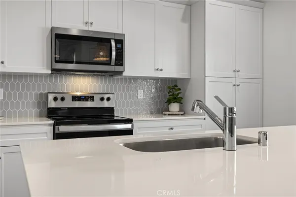 a kitchen with a refrigerator sink and microwave