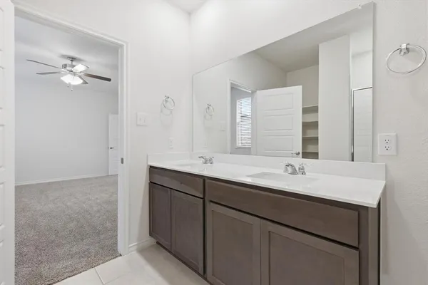 a bathroom with a double vanity sink and mirror
