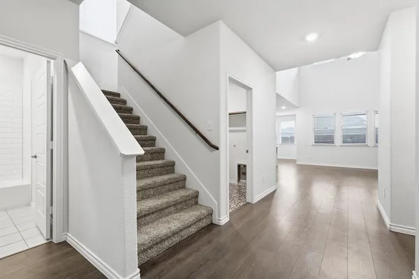 a view of a hallway with wooden floor and entryway