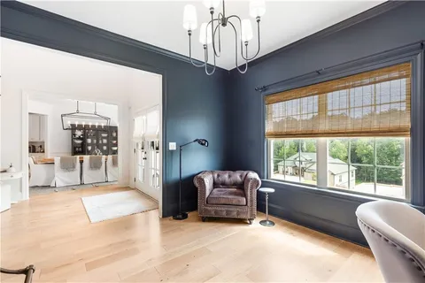 a bedroom with furniture and a large window