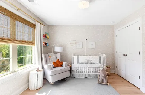 a living room with furniture a fireplace and a floor to ceiling window