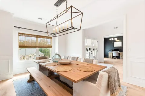 a dining room with furniture and wooden floor