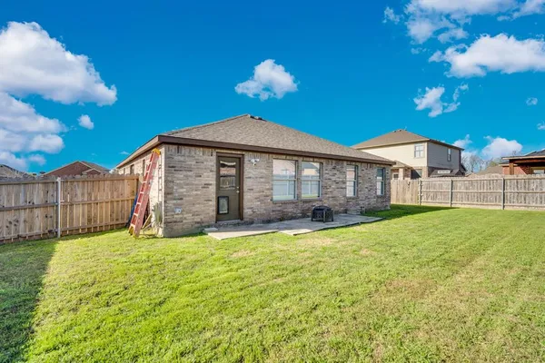 a view of a house with a yard and sitting area