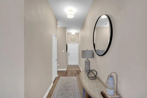 a view of a livingroom with furniture and a mirror