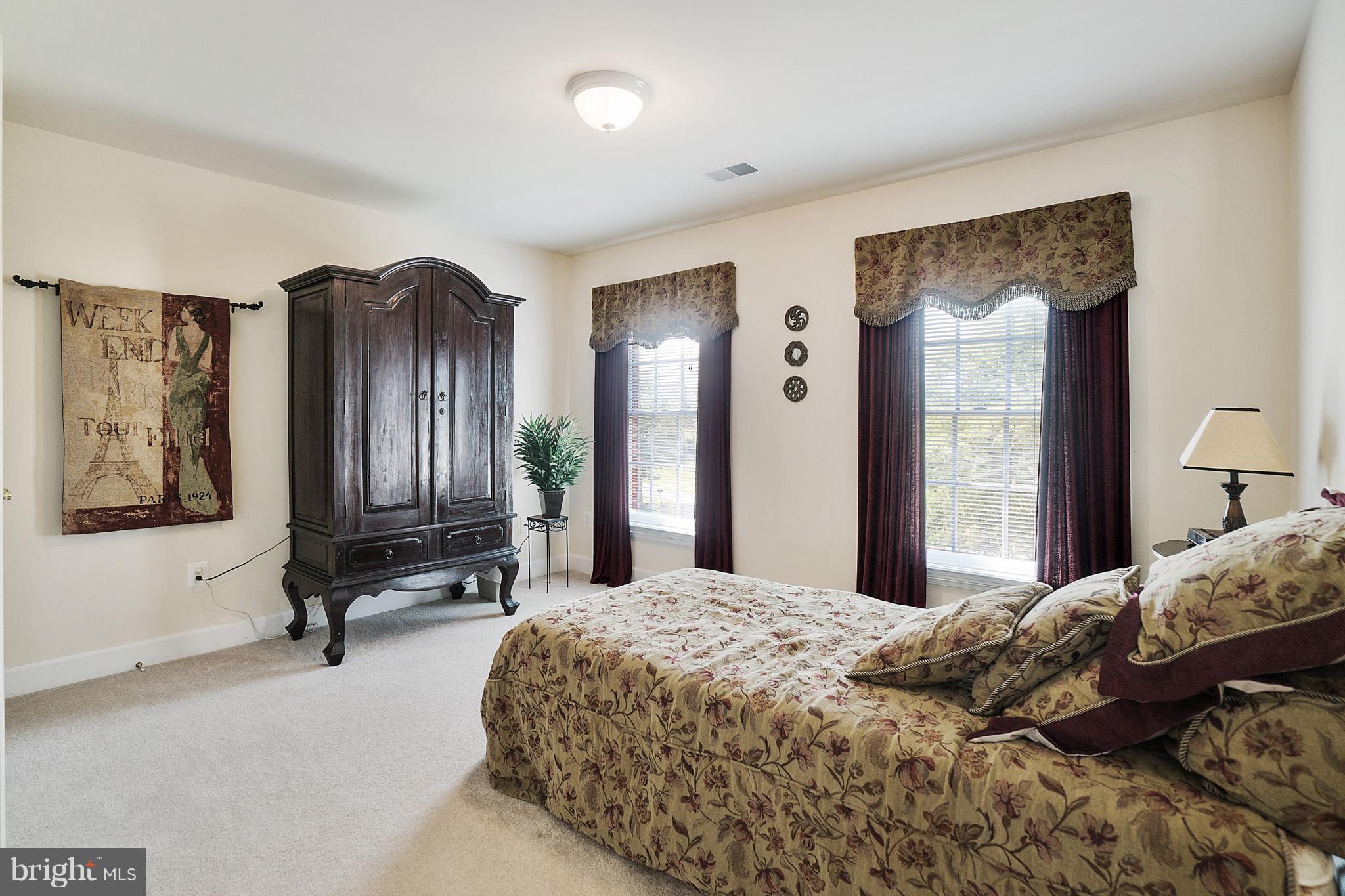 14401 Autumn Rust Road Boyds, MD 20841 - Photo 22 of 30 a bedroom with a bed a dresser and mirror