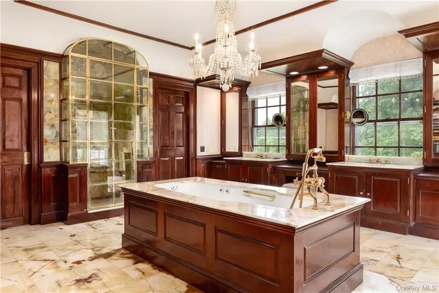 a view of kitchen with a sink a fireplace and a chandelier