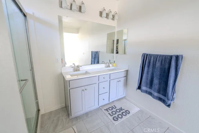 a bathroom with a sink a mirror and a shower
