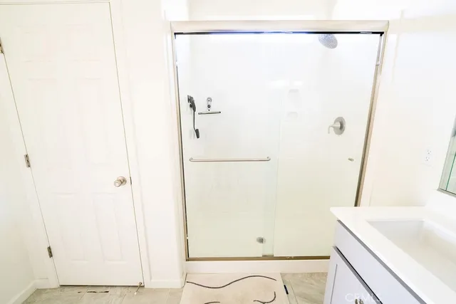 a bathroom with a shower and a sink