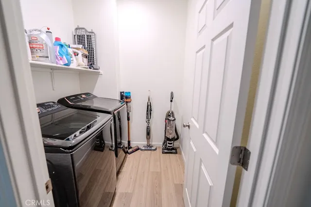 a view of a storage and utility room with washer and dryer