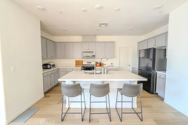 a kitchen with stainless steel appliances a refrigerator stove microwave and cabinets