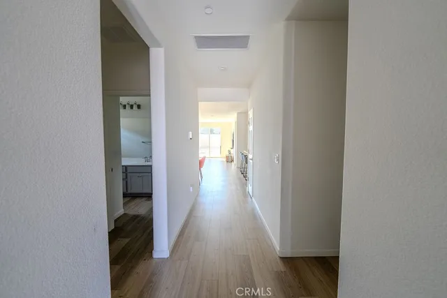 a view of a hallway with wooden floor