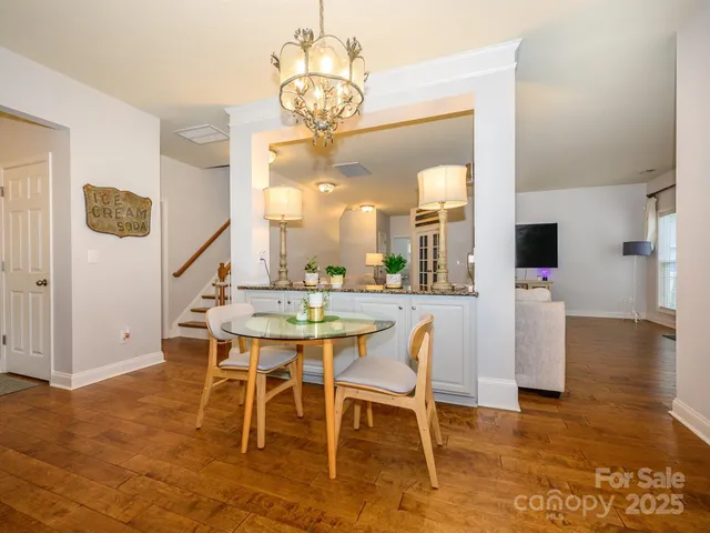 a dining room with wooden floor and breakfast area