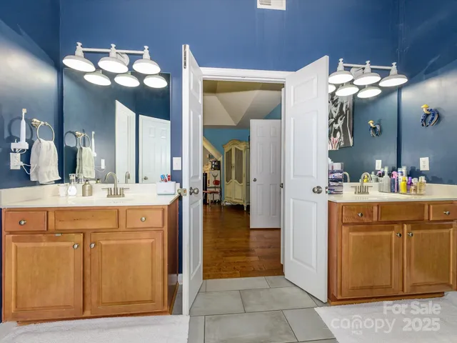 a bathroom with a sink vanity and a mirror